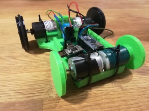 View the event “Pocket League”; image description: A home-made mini robot with visible wiring